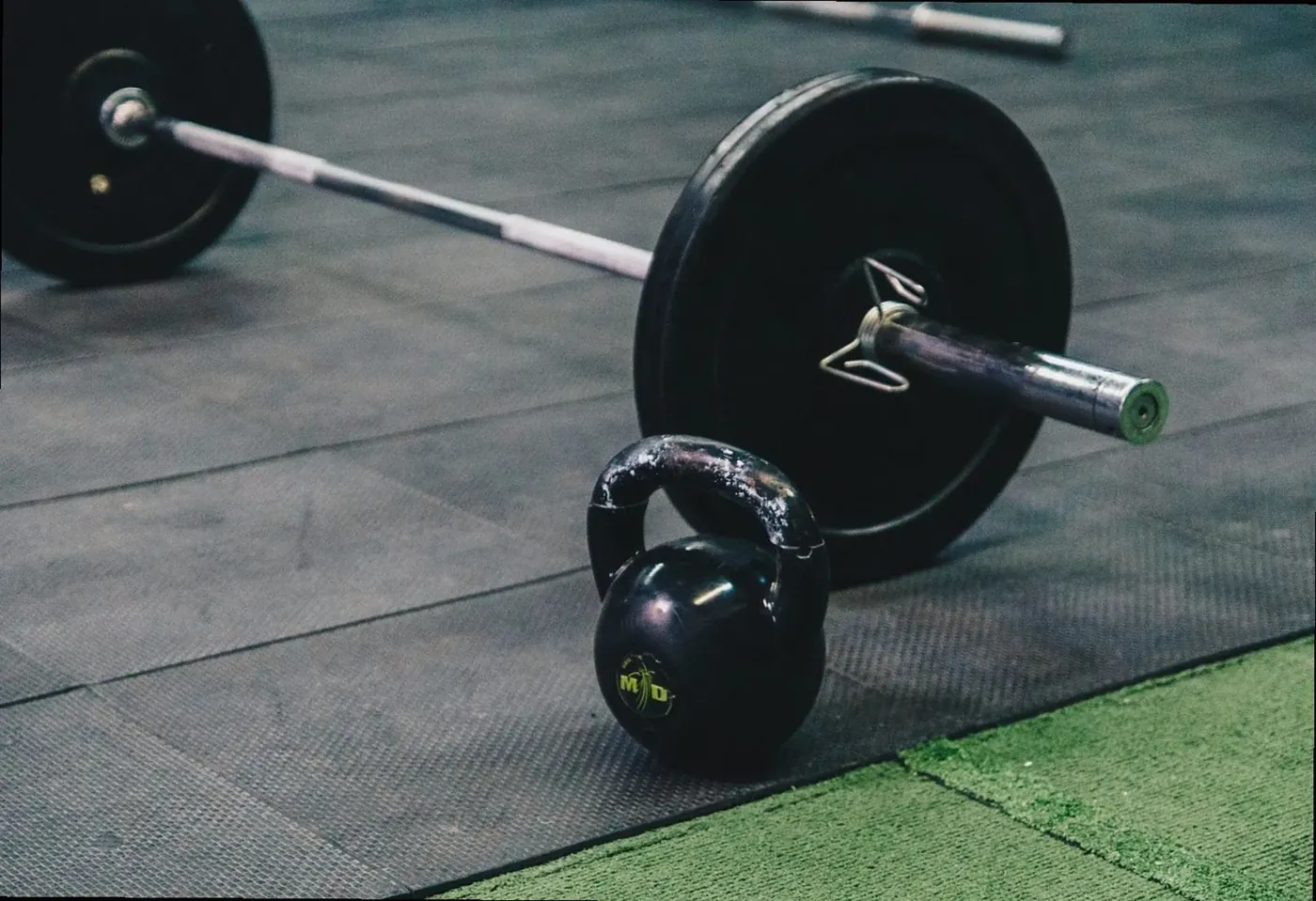 Barbell and kettlebell on the rubber gym floor